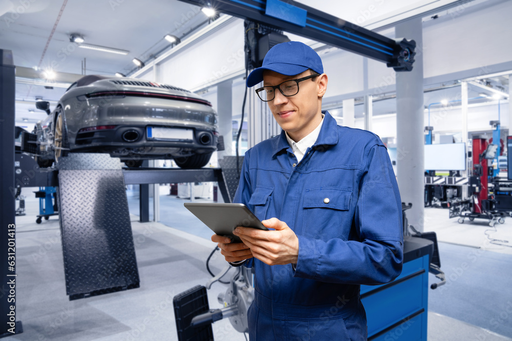 Poster serviceman with digital tablet on the background of the car in the car service.