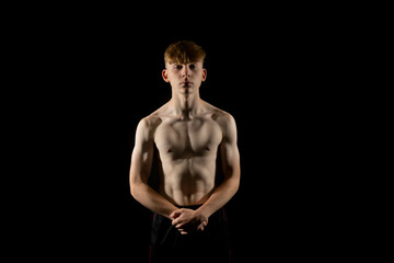 Naklejka premium Teenage boy flexing his muscles