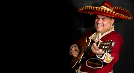 Mexican mariachi musician on a black background.