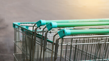 Metal shopping carts on dark background concept of shopping on holiday                               