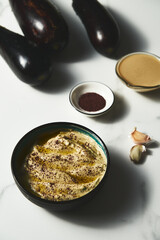 Mutabal or Moutabal - Middle Eastern dip made from roasted eggplants with tahini, garlic and lemon juice. It's creamy, smoky, and tangy.