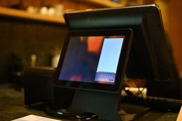 A cashier machine with screen at modern restaurant or cafe.