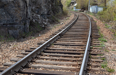 Fototapeta premium railroad near a rock with shiny rails