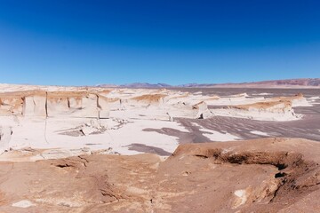 Stunning barren area in a white desert with volcanic rock formations in Campo De Piedra Pomez