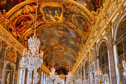 Versailles, France - April 8th, 2022: Ornate painted ceiling of the famous Hall of Mirrors inside of the Versailles Palace.