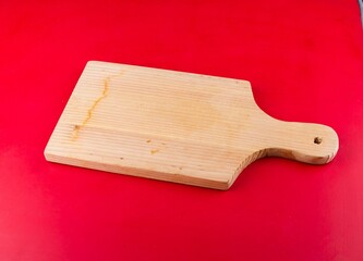 Image of a  wooden board isolated on a red background