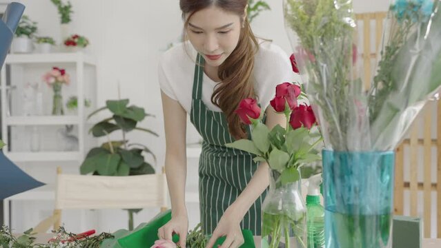 Asian florists work in her own shop. Small business, Owner business.