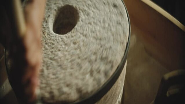 Close-up view of a person rolling the flour mill