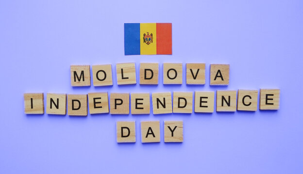 August 27, Moldova Independence Day, flag of Moldova, minimalistic banner with the inscription in wooden letters on a blue background