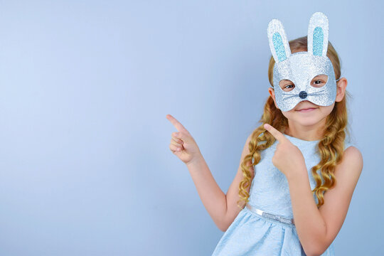 A child in a masquerade carnival mask of a hare or a rabbit, made by hand from shiny glitter foamiran and sequins. Masquerade, Carnival, Party, Holiday, Birthday
