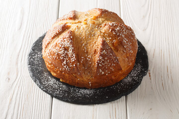 North african and french sweet easter brioche mouna bread closeup in a plate on the table. horizontal