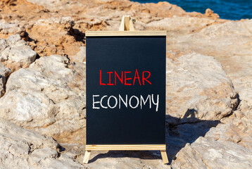 Linear economy symbol. Concept words Linear economy on beautiful black blackboard. Beautiful sea...