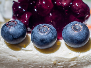 Three blueberries on top cake with blueberry jam in dessert shop