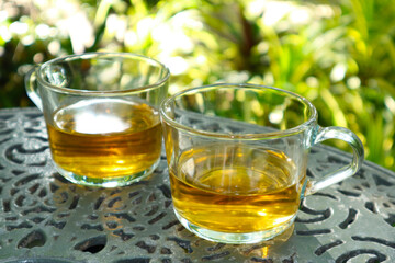 Two Half Glasses of Tea on the Garden Table During the Teatime