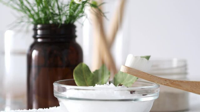 Coarse sea salt for cleaning teeth is poured into a container. Natural dental health, beauty treatments, zero waste concept. Salt is an ingredient for osmetic procedures. Beauty care concept