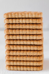 Stacked sugary biscuits on a white background. Side view. Close up.