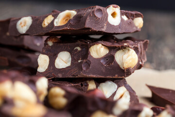 Pieces of homemade milk chocolate with lots of hazelnuts