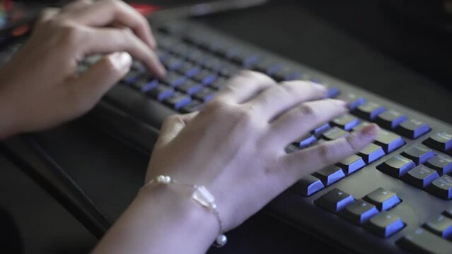 Female teenager hands typing on laptop Personal Computer keyboard