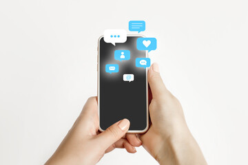 female hand holding and using a social media on mobile phone with notification icons