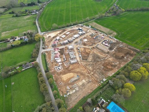 New build houses under construction in Finchingfield Essex England drone aerial view