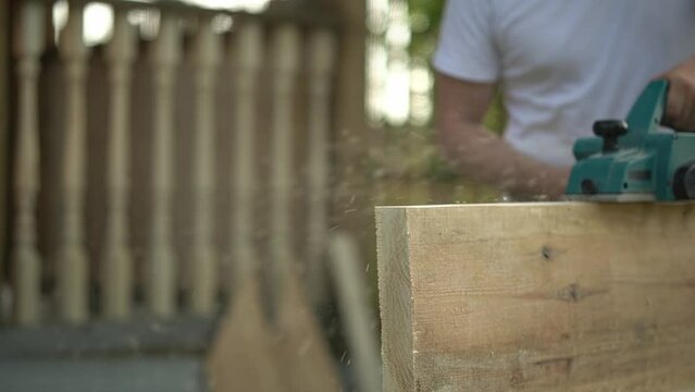 wood processing. a man works with an electric planer. close-up of an electric planer. slow motion video. High quality FullHD video recording