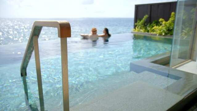 Honeymoon Couple leaving pool in luxury villa