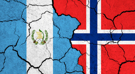 Flags of Guatemala and Norway on cracked surface - politics, relationship concept