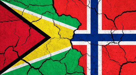 Flags of Guyana and Norway on cracked surface - politics, relationship concept