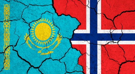 Flags of Kazakhstan and Norway on cracked surface - politics, relationship concept