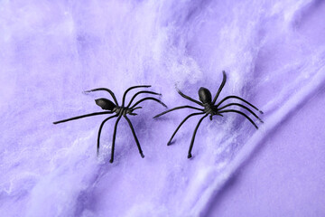 Cobweb with spiders for Halloween party on lilac background