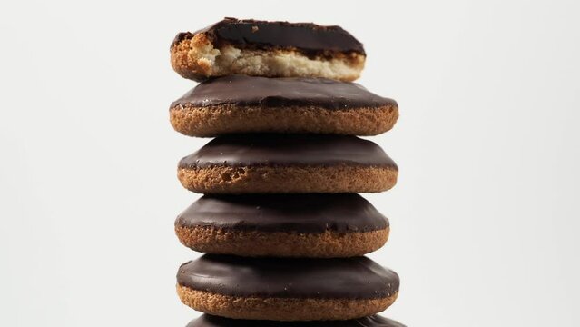 Rotating cookies with dark chocolate and orange marmalade. Cookies on a white background.