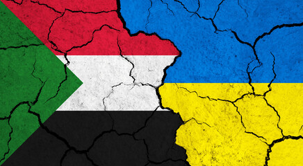 Flags of Sudan and Ukraine on cracked surface - politics, relationship concept