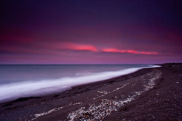 Landscape at dusk, on a pebble beach