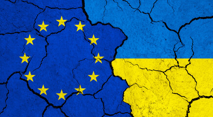Flags of European Union and Ukraine on cracked surface - politics, relationship concept