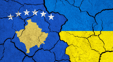 Flags of Kosovo and Ukraine on cracked surface - politics, relationship concept