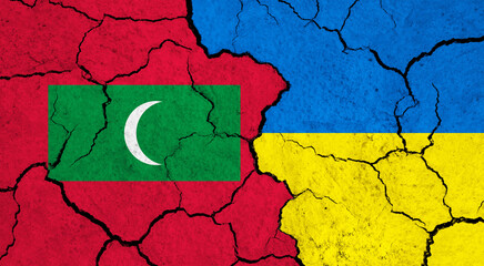 Flags of Maldives and Ukraine on cracked surface - politics, relationship concept