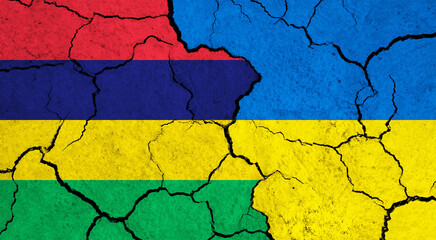 Flags of Mauritius and Ukraine on cracked surface - politics, relationship concept