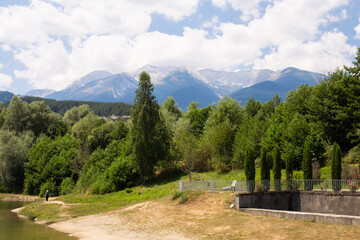 View of the lake among the forest and mountains in Bulgaria on a sunny summer day