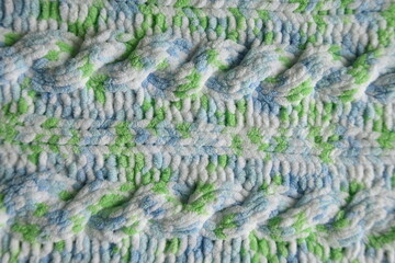 Blue and green Aran braid cable stitch knitting pattern background