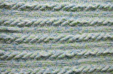 Blue and green Aran braid cable stitch knitting pattern background