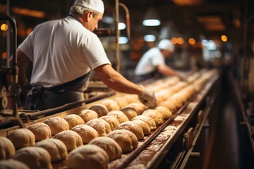 Keuken foto achterwand Brood workers sorting bread on bakery factory