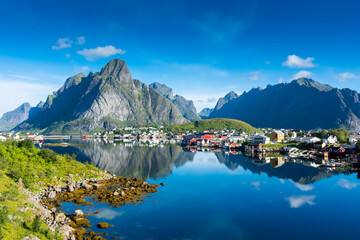 Perfect reflection of the Reine village on the water of the fjord in the Lofoten Islands,  Norway