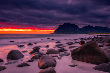 Dramatic midnight sunset with amazing colors over Uttakleiv beach on Lofoten Islands,  Norway