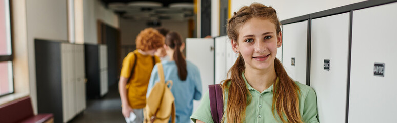 banner, positive teen girl looking at camera in school hallway, happy face, back to school concept