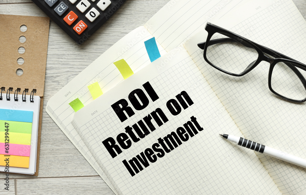 Poster open notepad with text. glasses on a notebook. text. return on investment, roi.
