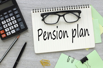 open notebook with glasses. calculator.text Pension plan