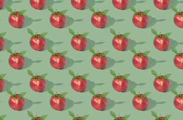 Pattern of nectarines on green pastel background