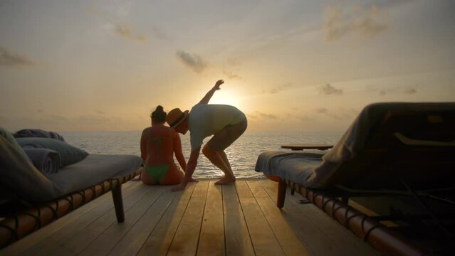 Couple enjoying sunset and kissing on luxury vacation