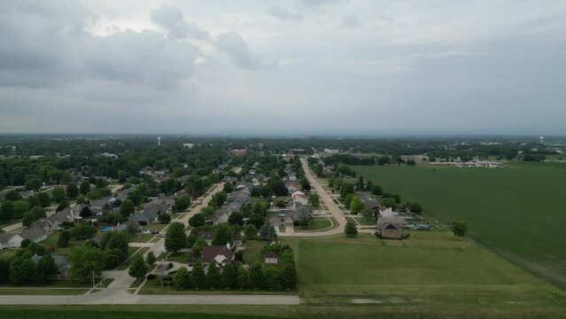 This is a sliding shot from right to left showing a typical rural farm town in Illinois on a cloudy summer day.