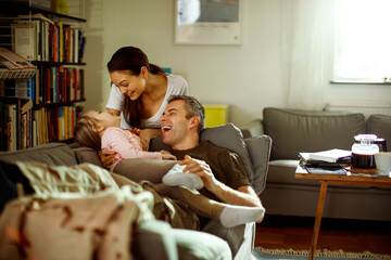 Father reuniting with his wife and daughter at home after deployment